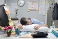 Office worker sleeping on desk