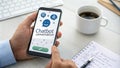 Office worker using chatbot conversation on smartphone app