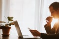 Office worker using phone and laptop working day indoors Royalty Free Stock Photo