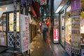Office worker walking the alley in Shinjuku district in Tokyo