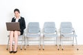 Office worker woman sitting on wood floor chair Royalty Free Stock Photo