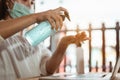 Office worker working from home during coronavirus outbreak cleaning her hands with sanitizer gel and wearing protective mask. Royalty Free Stock Photo