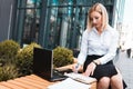 Office worker working on a laptop outdoor