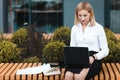 Office worker working on a laptop outdoor