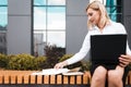 Office worker working on a laptop outdoor