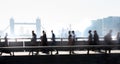 Office workers crossing the London bridge in early morning on the way to the City of London, UK