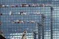 Office workers make use of the vantage point offered by the the balconies of their building on Lower Thames Street in London