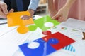 Office workers put together bright jigsaw elements Royalty Free Stock Photo