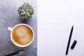 Office workplace with blank paper, cup of coffee and pen. Stone background. Top view Royalty Free Stock Photo
