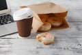 Office workplace with breakfast. Donuts and coffee Royalty Free Stock Photo