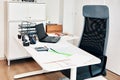 Office workplace with chair, laptop computer and a messy table Royalty Free Stock Photo