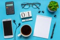 Office workplace with coffee cup, smart phone, calculator, stationery and plant. Date 01 March on wooden block calendar. White Royalty Free Stock Photo