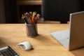 Office workplace. Color pencils, laptop computer and computer mouse on wooden desk in office. High quality photo Royalty Free Stock Photo