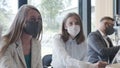 Office workplace with coronavirus safety measures. Young multiethnic business people meet at work wearing face masks. Royalty Free Stock Photo