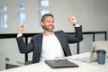 Office workplace. Excited business man working with laptop at desk in office. Businessman typing on keyboard online Royalty Free Stock Photo