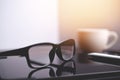 Office workplace, eyeglasses and tablet on Designer office table, eyeglasses on table