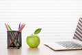 Office workplace with laptop, apple and pencils Royalty Free Stock Photo