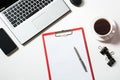 Office workplace with laptop, cup of coffee, accessories on white. Top view with copy space.