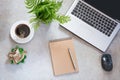 Office workplace with laptop, cup of coffee, sketch-book and plant. Top view with copy space. Royalty Free Stock Photo