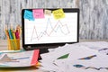 Office workplace with laptop and documents with statistic graphs. Royalty Free Stock Photo