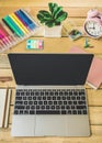 Office workplace with with laptop, reports and pencils on wooden desk table Royalty Free Stock Photo