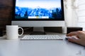 Office workplace with silver black monoblock pc and white keyboard and mouse on white table. Royalty Free Stock Photo