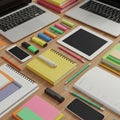 Office workspace with neatly arranged items: two open laptops, tablets, and