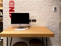 Office workspace station with apple iMac computer on a wooden table