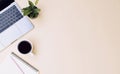 office workspace yellow desk table with laptop, coffee, mobile, notebook, plant Royalty Free Stock Photo