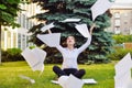 Office yoga. Business lady in lotus pose sits on green grass throws paper over head. Recreation of office staff. Positive emotions Royalty Free Stock Photo