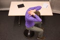Office yoga - business man exercising at desk Royalty Free Stock Photo