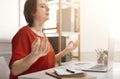 Business woman meditating near laptop