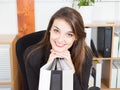 Office young Woman Sitting at Desk Leaning on Hands in Crossed While Smiling Royalty Free Stock Photo
