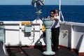 officer of cargo ship taking bearing of target point Royalty Free Stock Photo