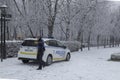 Officer gets out of the local police car, in a snowy day, Madrid