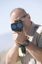 Officer Looking Through Radar Gun Royalty Free Stock Photo