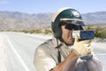 Officer Monitoring Speed Through Radar Gun