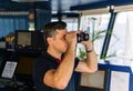 Officer during navigational watch looking through binoculars Royalty Free Stock Photo