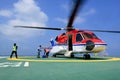 The officer take care passenger and load baggage to helicopter a Royalty Free Stock Photo