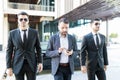 Officers Walking With Globally Known Entrepreneur Royalty Free Stock Photo