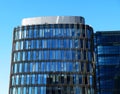 Offices building exterior in summer sunny day. Blue sky had been reflected in the glass of windows. Royalty Free Stock Photo