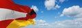 official flag of Austria and Germany Austria at cloudy sky background on sunset, panoramic view. Austrian travel and patriot