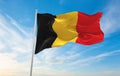 official flag of Belgium civil , Belgium at cloudy sky background on sunset, panoramic view. Belgian travel and patriot concept.