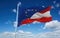 official flag of Europe and Austria Austria at cloudy sky background on sunset, panoramic view. Austrian travel and patriot