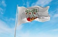 official flag of Frederiksberg, Denmark at cloudy sky background on sunset, panoramic view. Danish travel and patriot concept.