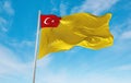 official flag of General Directorate of Health for Borders and Coasts of Turkey Turkey at cloudy sky background on sunset,