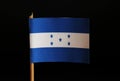 A official flag of Honduras on toothpick and on black background. Honduras is located in central america and belongs to poverty la