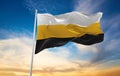 official flag of Perak Malaysia at cloudy sky background on suns