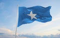 official flag of Somalia at cloudy sky background on sunset, panoramic view. patriot and travel concept. copy space for wide