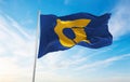 official flag of Tokushima prefecture waving in the wind on flagpoles against sky with clouds on sunny day. Japan Patriotic